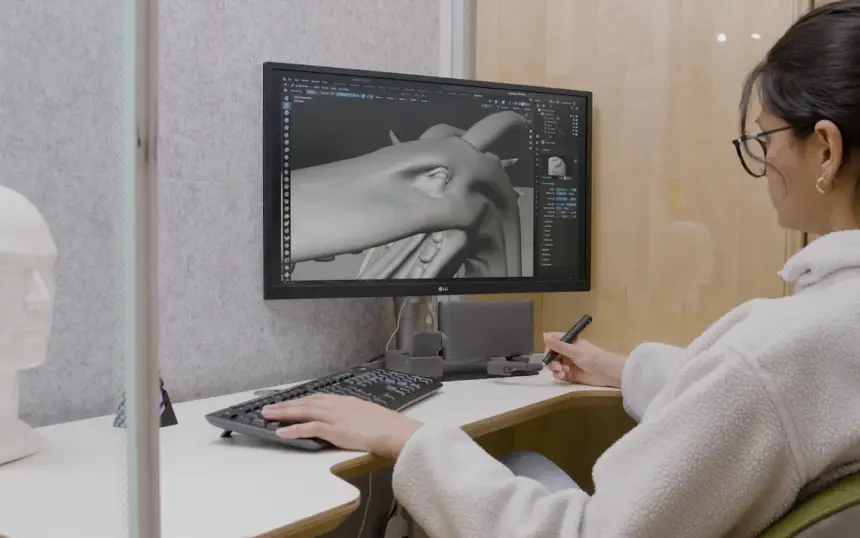 Designer sculpting a 3D model with haptic input
