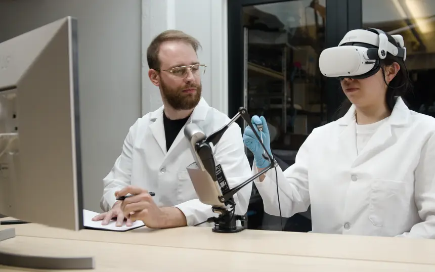 Trainee in a VR headset practicing a procedure with an Inverse3